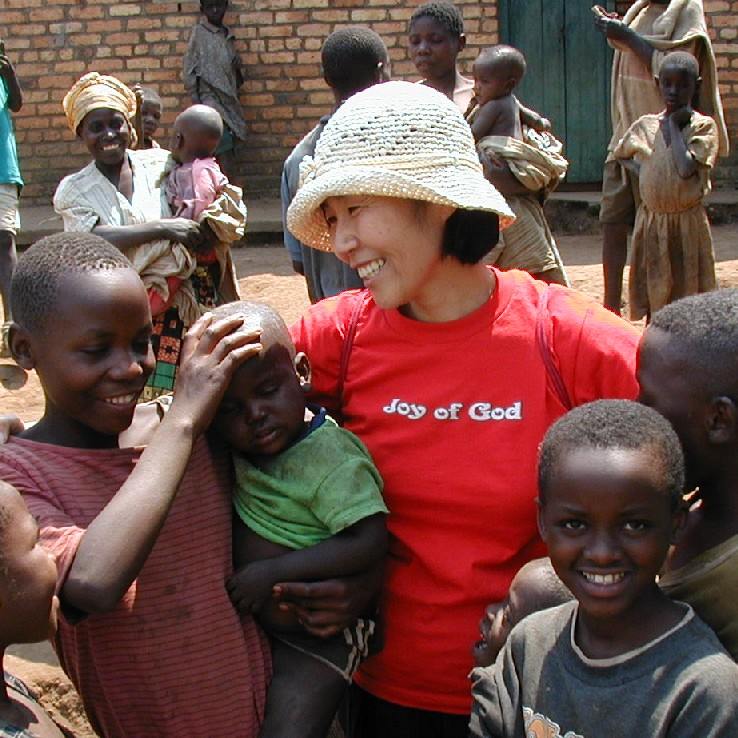 Kim with Batwa in Rwanda, Africa, in 2002
