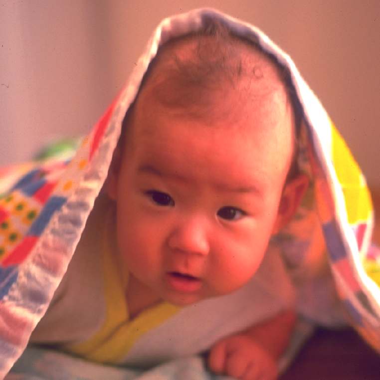Zachary under his blanket in 1975